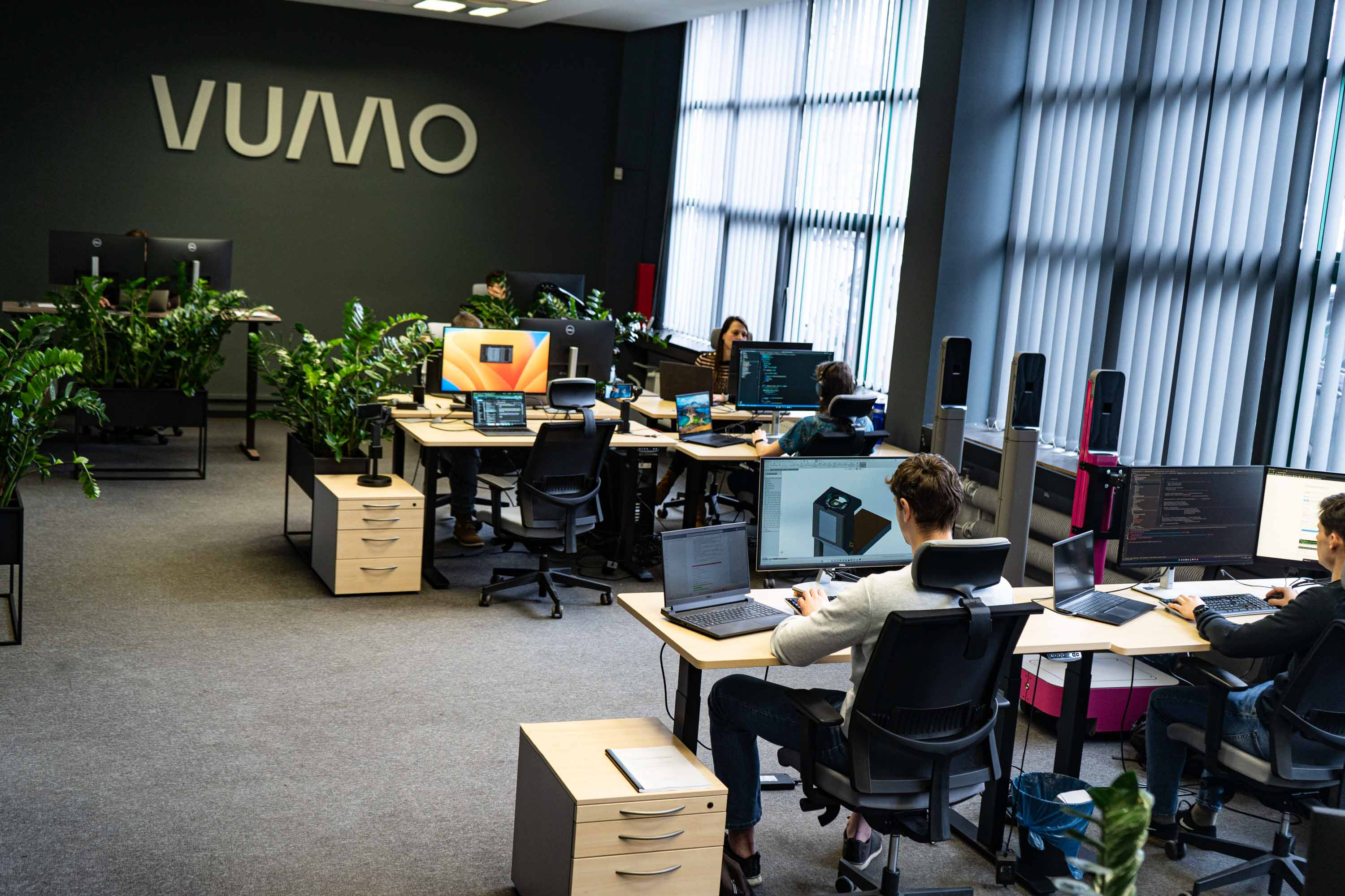 People sitting in front of computers in open space office